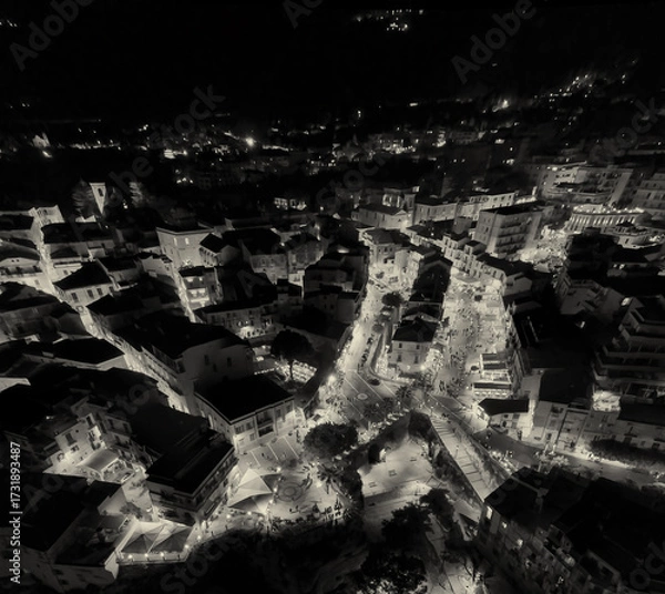 Fototapeta Aerial night view of Tropea town and coastline illuminated during summer from a drone