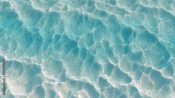 Fototapeta Ocean's Embrace: A mesmerizing aerial shot captures the radiant beauty of shallow water, revealing sun-kissed textures of the sea bed creating a natural, abstract patterns.