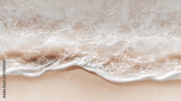 Fototapeta Seashore Serenity: A tranquil aerial view captures the gentle embrace of ocean waves meeting a pristine beach, invoking feelings of peace and calm.