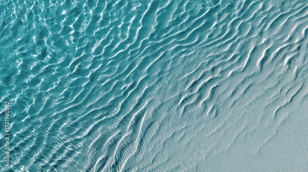 Fototapeta Aqua Ripples: An exquisite composition featuring the delicate dance of light on the textured surface of water, portraying an abstract depiction of natural ripples and mesmerizing aquatic patterns.