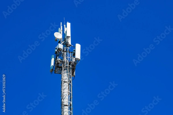 Fototapeta mobile communication and wireless internet 5g  antennas on mast against blue sky