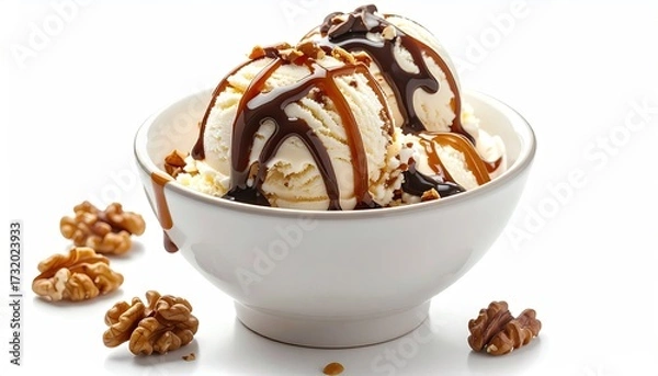 Obraz Two scoops of vanilla ice cream in a white bowl, drizzled with caramel and chocolate sauces, topped with walnuts