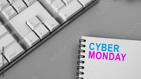 Fototapeta Closeup view of the text of Cyber Monday on a note on a gray background. Copy space. Cyber Monday sale concept