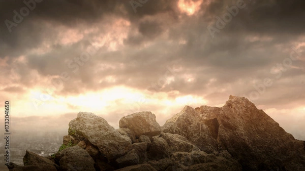 Fototapeta Pile of large rocks on the ground with dramatic sky background. The scene is scary and mysterious. Mockup. Copy Space. Wallpaper or Halloween background