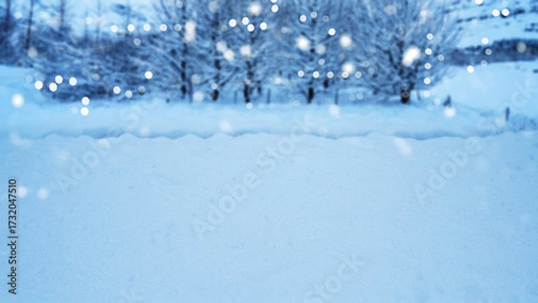 Fototapeta Winter scene with snowfall descending upon a snowy field and covering the ground and trees. Seasonal design or holiday themes for winter