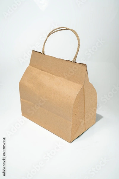 Fototapeta Blank empty plain brown paper shopping bags on a white background. Mockup, template, or copy space