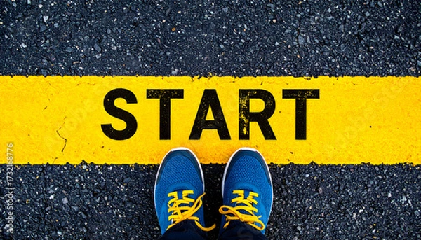 Obraz A pair of running shoes standing at the yellow start line, symbolizing new beginnings and motivation.