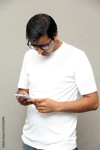 Fototapeta expressions of young amazed man isolated on gray background