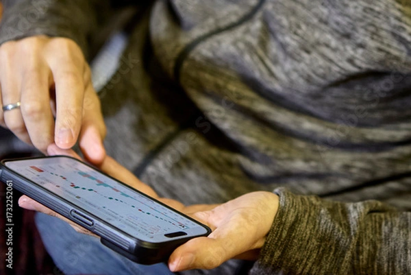 Fototapeta Horizontal view of man using smartphone indoors