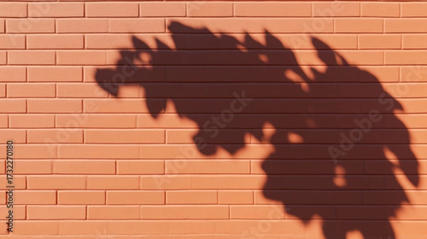 Obraz Light and Shadow, A serene image of tree branches casting shadows on an old brick surface, evoking tranquility and nature's beauty.