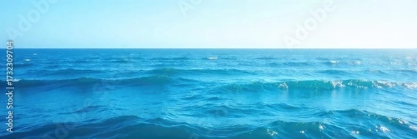 Fototapeta Vast expanse of deep blue ocean water, waves gently rolling under a clear sky Perfect for travel, nature, or environmental themes , serenity, offshore