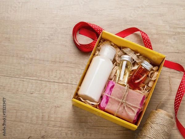 Obraz Cosmetics set in gift box. Body cream, essential oils, handmade soap