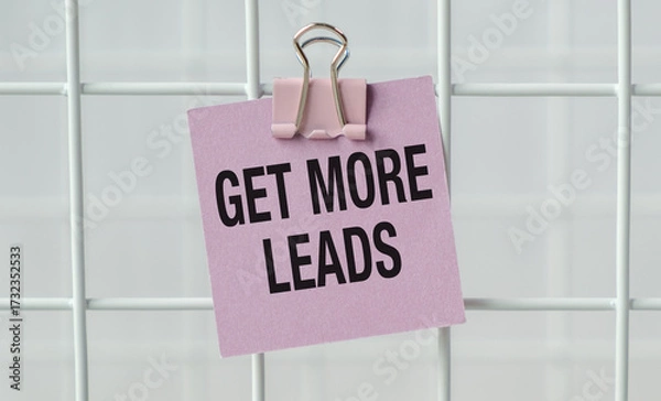 Fototapeta A pink note with a clip on it that says Get more leads