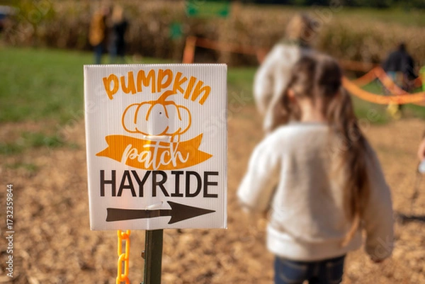 Obraz Pumpkin patch hayride sign isolated with cornfield and children lining up in the background