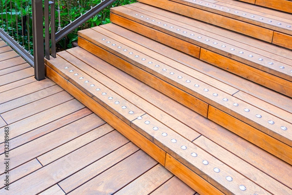 Fototapeta Teak wood steps with path of elevated walkway in public park area, High angle and perspective side  view with copy space