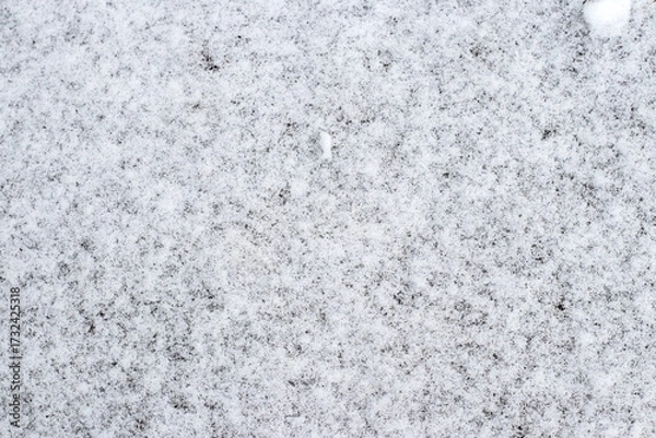 Fototapeta Abstract background view of the texture of the first snow covering the ground creating a winter pattern
