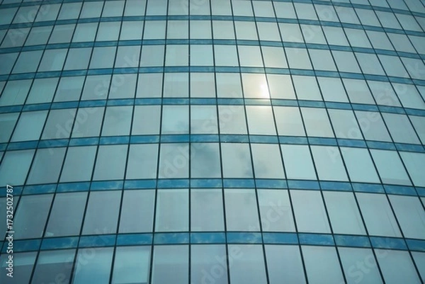 Fototapeta The texture of the windows of a tall skyscraper.