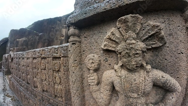Obraz The Rich Texture and Fine Craftsmanship of Ancient Rock-Cut Reliefs Adorning a Wall in the Kanheri Cave Complex, Evoking Spiritual Heritage.