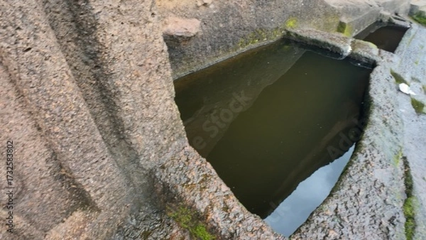 Obraz Engineering of the Ancients: Detailed View of a Carved Water Reservoir Used for Monastic Drinking Supply at the Historic Kanheri Caves Complex, Mumbai, India 