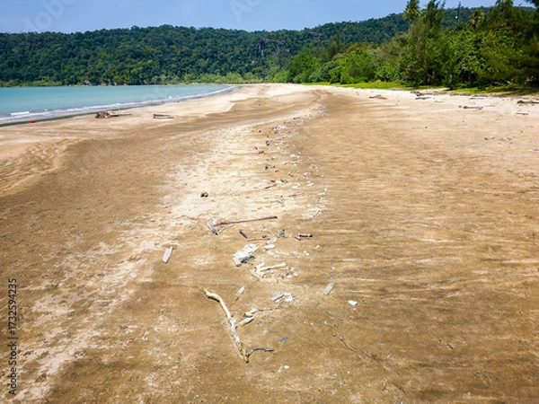 Obraz Plastic bottles and other waste washed ashore, spoiling a beautiful tropical beach