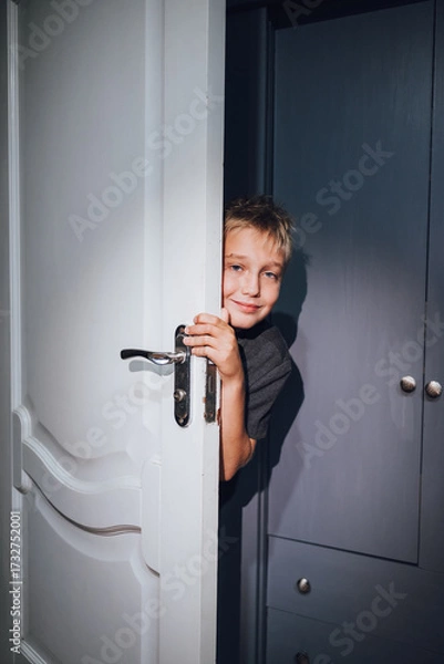 Obraz a handsome boy playing hide and seek