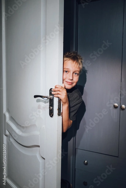 Obraz a handsome boy playing hide and seek