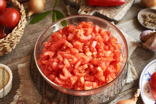 Fototapeta Chopped peeled tomatoes and spices - preparation of homemade relish (ajvar-style vegetable spread, chutney or bruschetta topping)