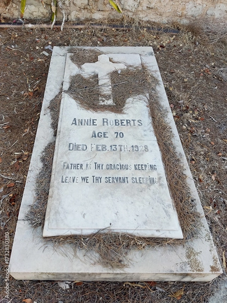 Fototapeta Haifa, Israel, 12 June 2025, at the Protestant Cemetery. The inscription on the gravestone reads. Annie Roberts.
 Epitaph: Father in thy gracious keeping, leave we thy servant sleeping.