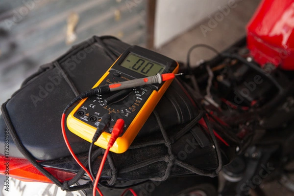 Fototapeta Digital multimeter on a motorcycle, closeup of photo with selective focus