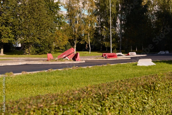 Fototapeta There are damaged traffic barriers on an abandoned roadway that has been left to nature