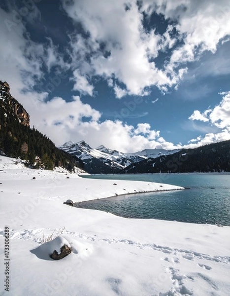 Obraz Snowy mountain lake under a dramatic sky