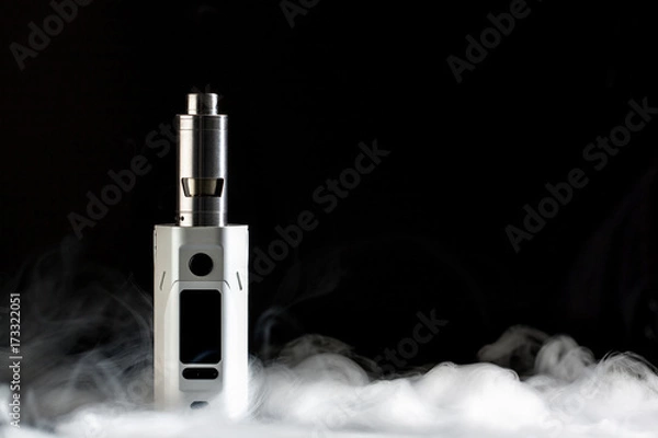 Obraz Electronic cigarette over a dark background.