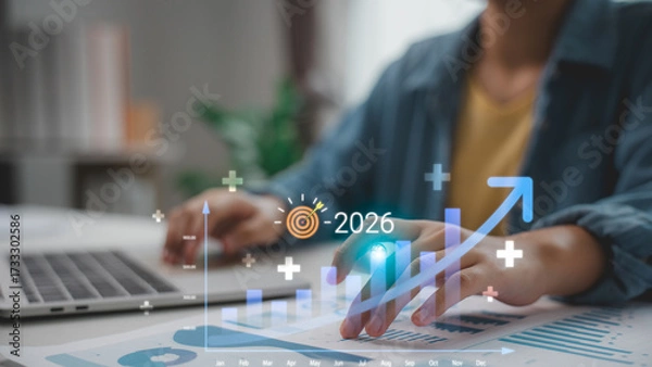 Fototapeta Hand pointing to a financial growth chart with upward trend and 2026 target icon. Concept for business analytics, financial forecast, investment growth, and strategic planning.