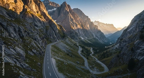 Obraz Winding road through majestic mountains at golden hour scenic landscape