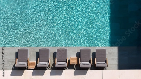 Fototapeta Swimming pool with sun loungers. View from above. luxury hotel resort. Aerial view of a luxury swimming pool.