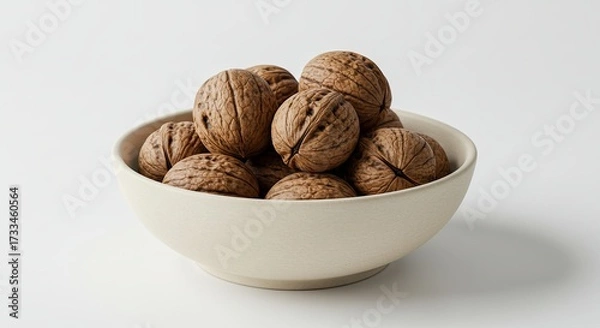 Fototapeta Bowl of Whole Walnuts on a White Background.
