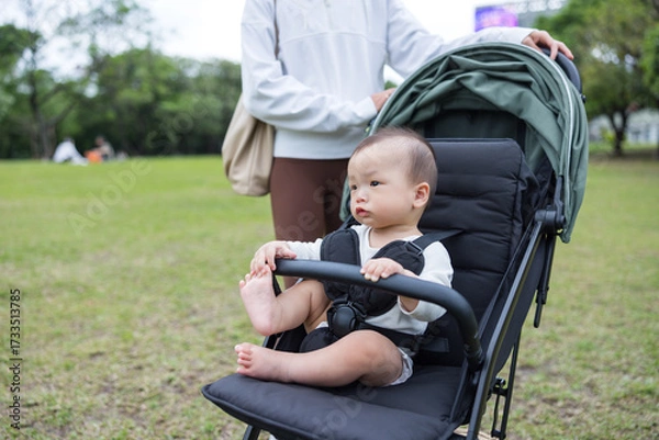 Fototapeta Infant enjoying ride in stroller at park