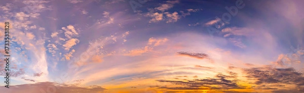 Fototapeta Real majestic sundown sky background with gentle colorful clouds evening sunset. Panoramic big size arched vaults of cirrus cloud in high-altitude wind flows and the dynamics of atmospheric fronts.