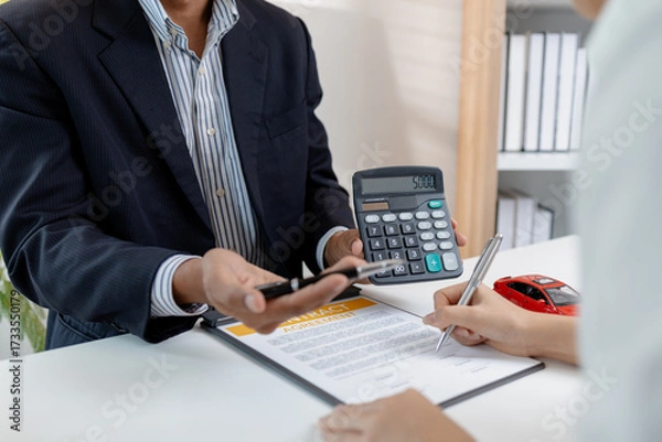 Fototapeta Business negotiation for car purchase shown with toy car models, car keys, calculator, and contract agreement. The images illustrate consultation, signing process, and financial decision.