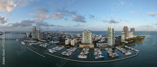 Fototapeta Panorama of Miami skyline and Biscayne Bay. Panoramic cityscape with coastal skyscrapers. Scenic view of Miami Beach from above. Drone captures Fisher Island and waterfront.
