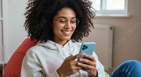 Obraz Woman smiles while using a mobile phone