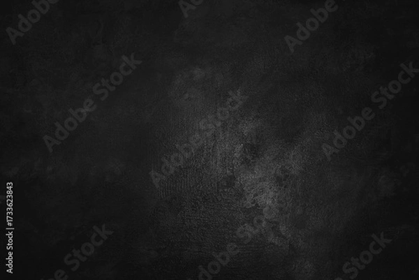 Fototapeta The texture of a black vintage plaster wall. The background is uneven in color, creating a sense of depth and distressed texture. The dark background can be used as a backdrop in a design