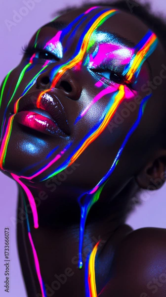 Fototapeta Model showcases vibrant light patterns on skin during artistic photoshoot in studio