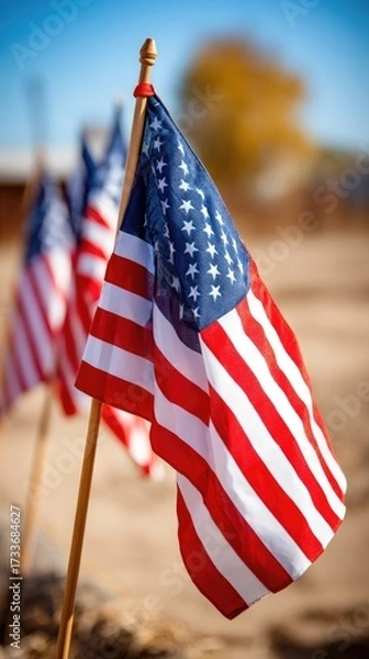 Fototapeta Proud display of American flags waving gently under clear blue skies at an outdoor location during the daytime