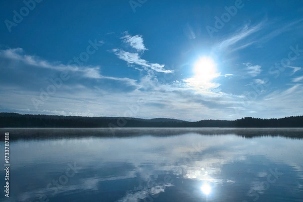 Fototapeta Sunset at the lake with reflection and forest, peaceful evening atmosphere