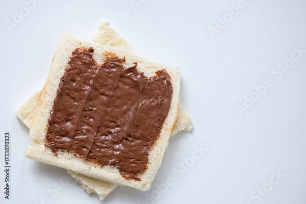 Fototapeta Close-up of white bread with chocolate jam