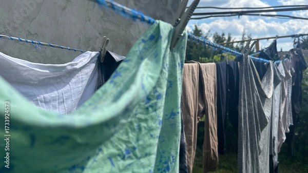 Fototapeta washed clothes and linens are drying on a line outside
