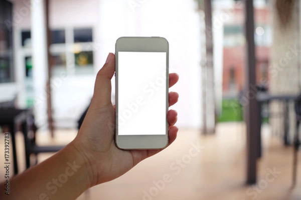 Fototapeta Close up of women's hands holding cell telephone blank copy space screen. smart phone with technology concept