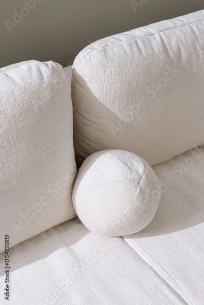 Fototapeta Minimalist couch design with soft textures in a cozy living room setup