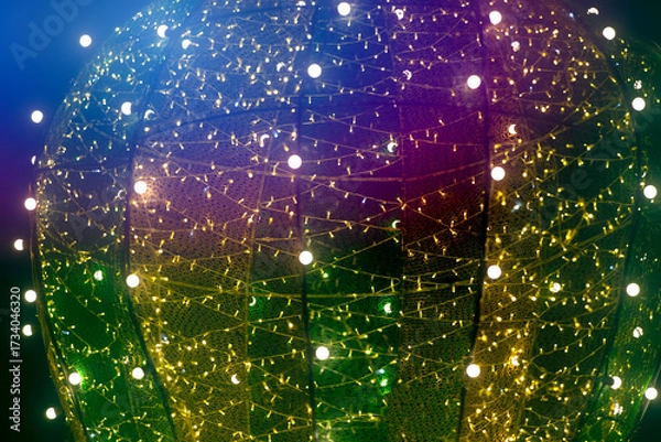 Fototapeta Decorative light installation shining brightly at a festive event in the evening twilight